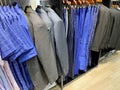 A collection of elegant men\'s trousers and casual pants hanging in a row in a men\'s fashion store Royalty Free Stock Photo