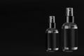 Collection elegant tall, low transparent spray dispenser bottle for cosmetics with black label on black background, mock up.