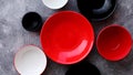 Collection of empty colorful decorative ceramic bowls on grey stone background.