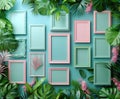 A collection of empty pink and blue picture frames arranged in a creative flat lay among vibrant tropical leaves. Royalty Free Stock Photo