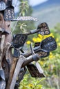 A collection of engraved tools hang in a tree in Cayambe in Ecuador in South America.