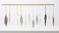 A collection of feather earrings hanging from a gold bar on a white background. This image is trendy and bohemian, with