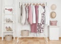 Collection of female clothes hanging on rack in dressing room