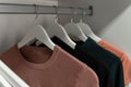 Collection of female clothes hanging on rack. Hangers with clothes. Royalty Free Stock Photo