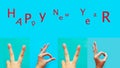 Collection of female hands gesturing the digits of the new year 2020 in sign language on blue background and the text - Happy New