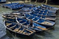 A collection of fishing boats tied up within the old fortress harbour at Essaouira in Morocco.