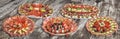 Collection Of Five Serbian Traditional Welcome Appetizer Savory Dishes Meze Displayed On Old Cracked Wooden Picnic Table