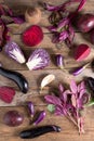 Collection of fresh purple fruit and vegetables on wooden background.