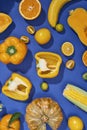Collection of fresh yellow fruit and vegetables on the blue background Royalty Free Stock Photo