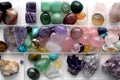 Collection of gemstones in a plastic box. Hobby healing crystals Royalty Free Stock Photo