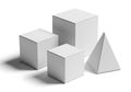 Collection of geometric solid shapes including cubes and a pyramid on a white background Royalty Free Stock Photo