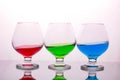 Collection of glasses with colored drinks