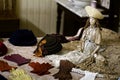A Collection Of Gloves In Front Of A Vintage Porcelain Doll