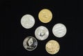 A collection of gold and silver cryptocurrency coins