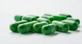 A collection of green capsules on a white background