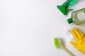 Collection of green and white cleaning supplies on white background. Detergents in plastic bottles. Flat lay. Close up Royalty Free Stock Photo