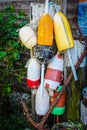 Collection Of Grungy Colorful Bouys Tied To Old Post With Rusty Anchor