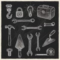 Collection of hand-drawn tools and hardware elements on a chalkboard surface displayed artistically Royalty Free Stock Photo