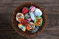 Collection of Hand Painted Colorful Cartoon Rocks in w Wicker Ba
