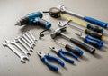 A collection of hand tools arranged on a flat, gray surface. Royalty Free Stock Photo