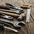 A collection of hand tools is arranged on a rustic wooden surface Royalty Free Stock Photo