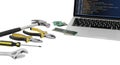 Collection of hand tools and a laptop displaying code isolated on white background Royalty Free Stock Photo