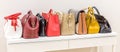 Collection of handbags standing in a row