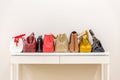 Collection of handbags standing in a row