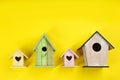 Collection of handmade bird houses on yellow background, flat lay Royalty Free Stock Photo