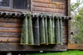 Collection of hip waders hanging up drying outside on a rustic wood cabin Royalty Free Stock Photo