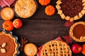 Collection of homemade fall pies. Top view frame on a dark wood background.