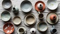 Collection includes bowls plates cups and vases in earthy tones of beige gray Royalty Free Stock Photo