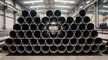 Stacked metal pipes form hypnotic tunnels in a vast factory setting Royalty Free Stock Photo