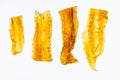 Collection of irregular, yellowish dried fish sheets on a light grey background Organic texture, consistent yellow hue with subtle Royalty Free Stock Photo