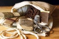 COLLECTION OF ITEMS IN A DARNING AND SEWING MILITARY REPAIR KIT CONTAINED IN A WHITE CLOTH BAG