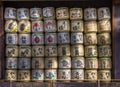 A collection of Japanese sake barrels stacked in shrine