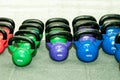 Collection of kettlebells on the gym floor.