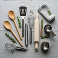 A collection of kitchen utensils is arranged on a gray fabric background Royalty Free Stock Photo