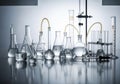 A collection of laboratory glassware arranged on a reflective surface. Includes beakers, flasks, Royalty Free Stock Photo