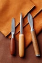 Leather crafting tools arranged on a rich brown surface, showcasing the beauty of craftsmanship with textures of leather Royalty Free Stock Photo