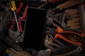 Collection Leather toolbelt hard hat on wooden board maintenance concept, on top is a smartphone. tools that make repairs in Royalty Free Stock Photo