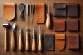 A collection of leatherworking tools arranged on a wooden surface Royalty Free Stock Photo