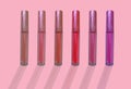 collection of liquid glossy lipstick tube on background, red, raspberry, pink, coral, peach color close-up, concept of decorative