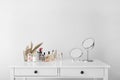 Set of decorative cosmetics and mirrors on dressing table Royalty Free Stock Photo