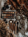 Collection of Makeup Tools and Natural Elements Arranged on a Textured Fabric Surface for Creative Beauty Applications Royalty Free Stock Photo