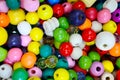 Collection of many colourful beads inside a wooden baske Royalty Free Stock Photo