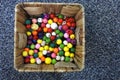 Collection of many colourful beads inside a wooden baske