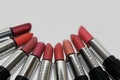 A collection of Mary Kay lipsticks in different shades lying open on a white background close up