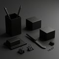 A collection of matte black office items arranged on a dark surface. The setup includes Royalty Free Stock Photo