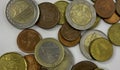 collection of mixed euro coins scattered on a white surface. The image shows various denominations in different metallic Royalty Free Stock Photo